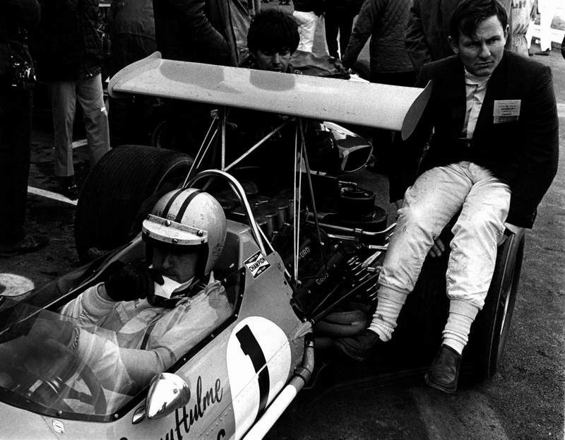 Denny in the M7B with Bruce sitting on the rear wheel at Watkins Glen 1968 (photo by Lionel Birnbom)