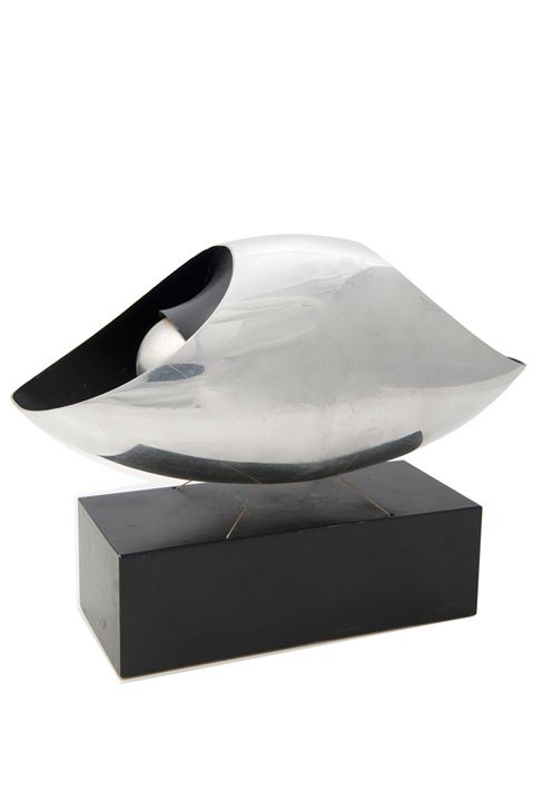 The trophy for this month is the trophy for winning the six race 1967 Canadian American Challenge Cup (Can-Am) series. The series that year was six races in total and with two wins and two seconds gave Bruce the points to be the overall series winner, he was driving the McLaren M6A-Chev.
Johnson Wax was the principle sponsor of the Canadian American Challenge Cup (Can-Am) and commissioned the cup that the Can-Am Challenge is all about. Not a cup at all, it is an abstract sculpture that seemed too offbeat for a racing trophy when it was first shown. It was called the “Floatile”, and has gained worldwide fame as the symbol of the richest racing series. 
The picture is of Bruce & Dennys cars in the pits at the Stardust circuit in Las Vegas.