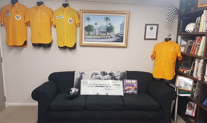 We are always very proud and humbled when someone thinks of us and donates memorabilia that relates to Bruce McLaren and his racing team. This item has the most zeros of anything we have received so far.
All thanks to Rich McConnell who very generously sent it to us so that it can be enjoyed by our many visitors.
This is a publicity cheque presented by Can-Am principle sponsor J Wax to Bruce McLaren Motor Racing Ltd in 1971 -  the amount $ One Million Can-Am Dollars.
We have taken the picture in the Bruce McLaren Heritage Centre Trophy Room with the Floatile, which was won by Bruce McLaren in 1968 as the trophy for the Can-Am series winner on the McLaren family couch from Remuera and with McLaren team shirts.